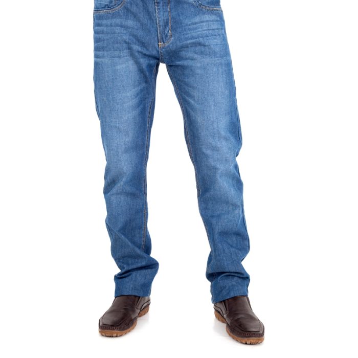 Model wearing Classic Comfort Fit Trousers in blue denim with brown shoes.