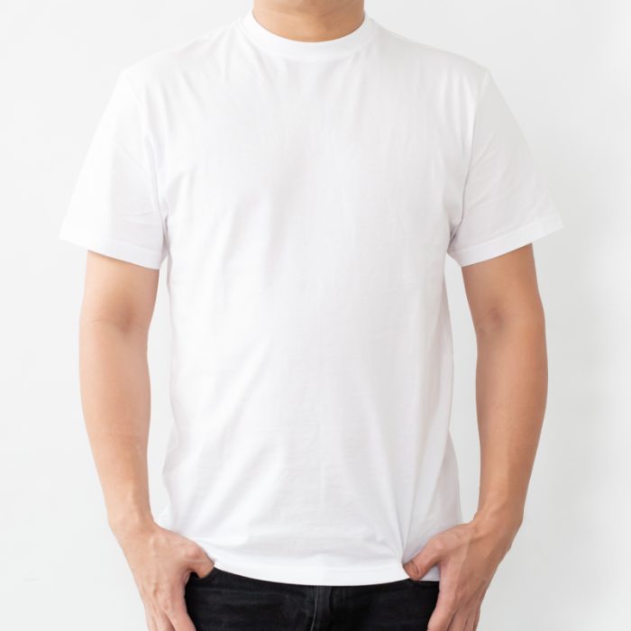 Man wearing a plain white t-shirt, standing against a neutral background.