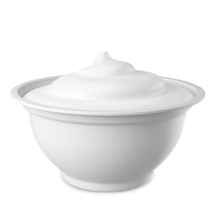 Bowl of natural plain yogurt with a smooth, creamy texture on a white background.